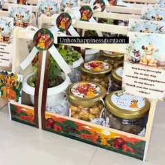 A fantastic 'Lion King' themed first birthday return gift. This basket includes a plant, jars of treats with custom 'Hakuna Matata' labels, and a personalized thank you card from the birthday boy.
