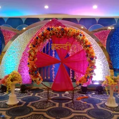 A different view of the luxurious Haldi stage, showcasing the vibrant lighting and the scale of the floral decoration that creates a rich and festive look.