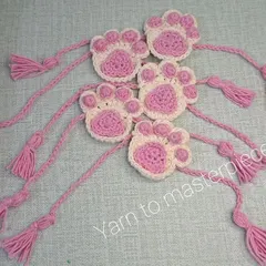A closer look at the crochet paw print rakhis. I make these with soft cotton yarn so they are comfortable to wear all day.