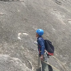A climber prepares to rappel after a long multi pitch climb. Mastering technical skills like this is crucial for big wall adventures.