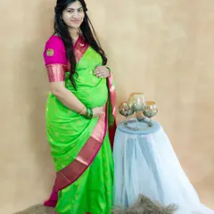 A lovely studio portrait of a mom-to-be in a vibrant lime green and pink silk saree. This shot is simple, beautiful, and full of color.
