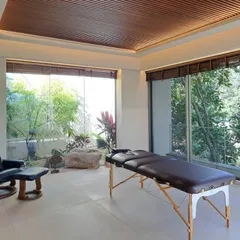 We created a dedicated spa and massage room in this "House in the Hills." A large glass window looks out onto a tranquil garden with natural rocks, bringing the calming elements of nature into this space of relaxation.