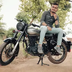 An outdoor portrait session featuring a Royal Enfield in a rustic, natural setting. These shoots are perfect for couples who love adventure and the outdoors.