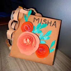 A close-up of the finished paper purse, showing the 3D paper flowers and hand-drawn details. It’s a beautiful example of turning simple AWT material into a showstopper.