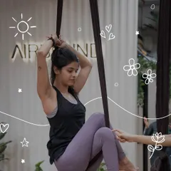 A participant prepares for a move on the aerial silk. This shot captures the focus and determination required for this beautiful art form.
