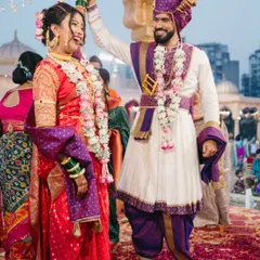 A celebratory moment right after the main rituals, showcasing the couple's happiness and traditional Marathi wedding attire.