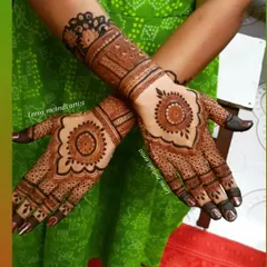 A lovely mandala design for a wedding guest. The central mandala is surrounded by a heart-shaped border, with intricate patterns on the fingers and a complementary wrist cuff.