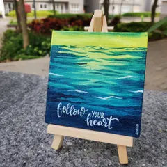"Follow your heart" painted on a mini canvas. I created a soothing ocean wave background with acrylics and added the motivational quote in calligraphy. These mini easels make them perfect for desk decor.