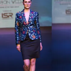 Capturing a modern, structured look on the runway. This image highlights a floral blazer and the model's strong presence, demonstrating my ability to freeze key moments during a fashion show.