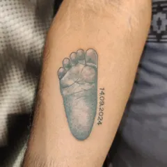 A very personal tattoo for a new parent, featuring their baby's footprint and birth date. I can work with you to create a design that immortalizes these precious early moments.
