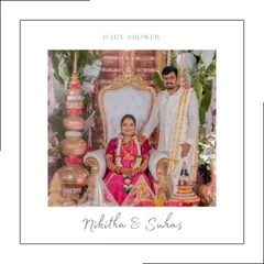 The parents-to-be seated for the main ceremony, looking regal and happy. This shot captures the central point of the baby shower, surrounded by traditional decorative elements.