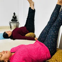 Viparita Karani, or Legs-Up-the-Wall Pose, is one of the most restorative postures in yoga. Here, students use cushions for support to help calm the nervous system, relieve tired legs, and promote deep relaxation.