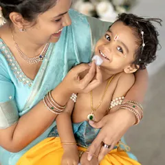 A playful moment between Yashoda and her little Krishna. The love and laughter are what make these photos so special.