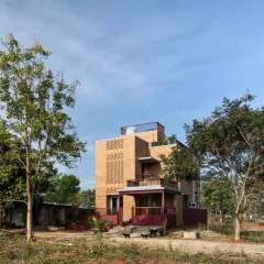 The Eesha residence is set amidst farms, designed to blend with its natural surroundings. The entire structure is built with exposed CSEB, creating an earthy, serene home that carries the essence of its rural setting.