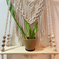 This bohemian macrame floating shelf is perfect for holding your favorite small plant, books, or candles. I make it with off-white cotton cord, wooden beads, and a solid pinewood plank.