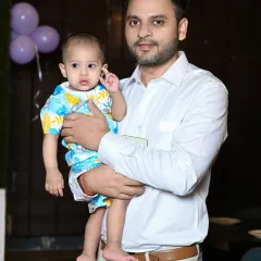 A simple and clean portrait of a father holding his baby.