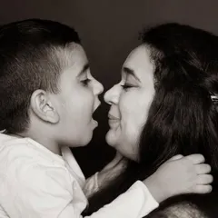 An Eskimo kiss between mother and son. Removing the color allows us to see the pure emotion, the texture of their connection, and the story in their eyes.