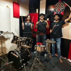 A group of new drummers posing with their sticks after a weekend workshop. You can feel the energy and excitement of learning a new, powerful instrument.