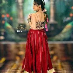 The full Navratri look, showcasing the vibrant red ghagra choli and the elegant hairstyle. The makeup is balanced to complement the colorful and traditional outfit.