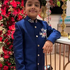 Looking like a little royal in our hand-worked blue sherwani. The intricate elephant motif on the chest and detailed collar embroidery add a touch of regal charm to this standout wedding outfit.