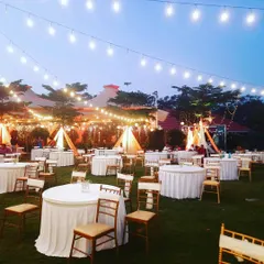 Another view of the outdoor evening setup, showing the combination of string lights and tented seating areas. This creates a comfortable and visually stunning environment for guests.