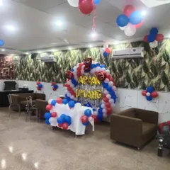 Inside the restaurant, I created a full backdrop for the celebration, featuring a balloon arch over a table and custom foil letters for the name 'Apaar Umang'.