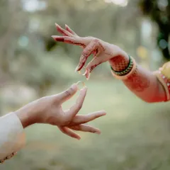 The ring exchange is more than just a ritual; it's a promise. I love finding creative ways to photograph this moment, focusing on the delicate hand gestures and the beautiful henna that tells its own story.