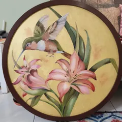 This piece, featuring a delicate hummingbird among lilies, was painted on a custom circular canvas. I used a soft, metallic gold background to give the scene a rich, warm glow, making it a unique and eye-catching piece of nature art for the home.