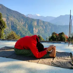 A still image capturing the deepest point of Paschimottanasana. This pose is not about touching your toes, but about lengthening the spine and releasing tension in the hamstrings and lower back.