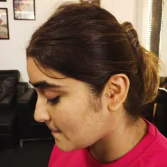 A wider view of the client with her new tragus piercing, showing how it fits into her overall style.