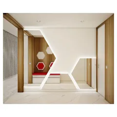 The entrance foyer of a luxury apartment, featuring a geometric theme. This design uses a bold, illuminated angular wall and hexagonal motifs to create a striking first impression, blending artistic form with practical elements like concealed seating and storage.