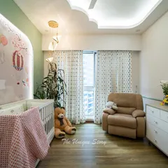 The nursery design includes a low chest of drawers for storage and a comfortable recliner next to the large window. The space is filled with natural light, creating a bright and cheerful atmosphere for the baby.