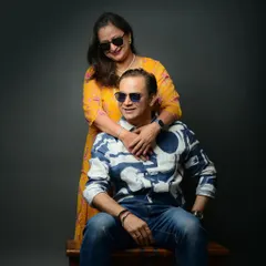 A fun and stylish shot from a 25th-anniversary session. Using props like sunglasses adds a playful and modern twist to the portraits.