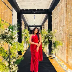 A classic red saree look for a wedding vibe. This elegant look was captured in a beautifully decorated hallway, perfect inspiration for a reception or cocktail party.