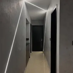 We turned this hallway into a runway with geometric lines of light. The integrated LED strips on the walls and ceiling create a futuristic and dynamic path, guiding you through the space.