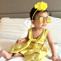 This little fashionista is rocking a custom yellow tie-front co-ord set. It's a chic and breezy outfit perfect for a stylish day out or a summer vacation.