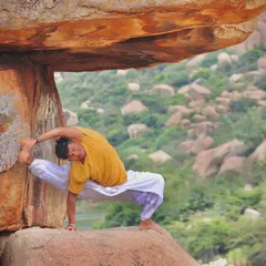 Using the support of a rock in Hampi to deepen a challenging side-body stretch. My practice is about constantly preparing my body and mind to break limitations and discover new abilities.
