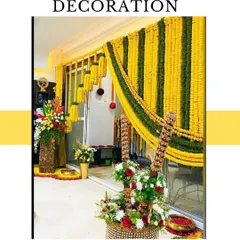 Here is an example of a home entrance decoration for a wedding event. I used curtains of yellow and green marigold strings to frame the doorway, making it festive and welcoming for guests.