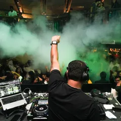 Fist in the air, surrounded by green smoke and an energetic crowd. This shot perfectly captures the peak-time madness and raw energy of my sets.