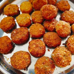 A tray of our signature veg cutlets, fresh out of the fryer. These are one of our most popular items and a staple in our party boxes and event menus.