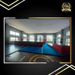 The spacious and well-lit Fly Zone action training hall, featuring large windows and professional-grade mats. This area is designed for gymnastics, martial arts, and stunt training.