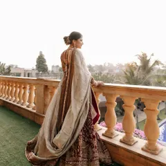 The bride, Prachi, looking out from a balcony at Della Resorts. This pensive, over-the-shoulder shot is both beautiful and full of emotion.