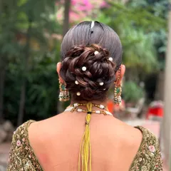 This is my take on the messy bridal updo, where technique meets artistry. I intricately wove the hair into a textured bun and scattered small pearls throughout for a touch of magic. It’s an elegant and modern choice for a bride who wants a sophisticated yet soft wedding hairstyle.