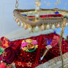 A close-up of our Krishna jhula, focusing on the decorated base with a mini tilak platter and tilak stick. Every element is thoughtfully placed to honor the auspicious occasion of Janmashtami.
