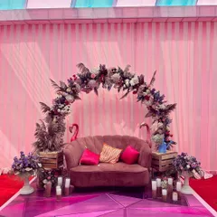 We created this fun photo booth with a plush pink sofa, a beautiful floral arch, and quirky flamingo props, making it a popular spot for guests at the Sangeet.