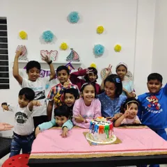 Another fantastic birthday celebration at the studio! Look at all those happy faces ready to dig into a colorful birthday cake.