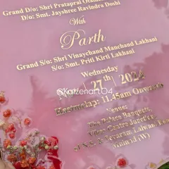 A detailed shot of the pink resin Kankotri, showing the elegant script and the placement of the dried flowers along the border.