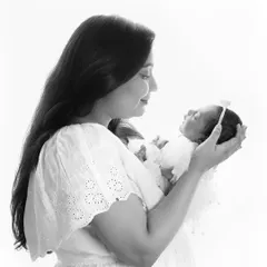 A classic black and white portrait of a mother holding her newborn. This image perfectly captures the feeling of holding your whole world in your arms.