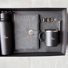 This all-black gift set for WROGN showcases a modern and professional aesthetic. The five-piece set includes a bottle, diary, mug, pen, and keychain, all customized with the brand logo.
