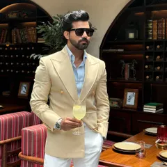 A closer perspective on our beige double-breasted blazer, highlighting the sharp tailoring and the way it complements the light blue shirt for a classic, sophisticated pairing.